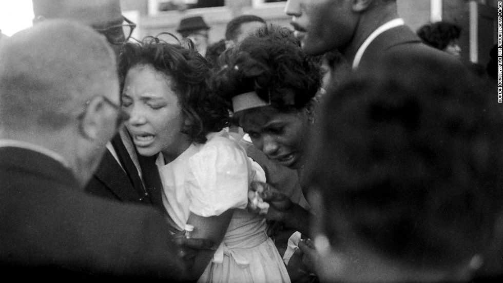 Mourners embrace at the funeral. In his eulogy, Dr. King said, &quot;These children -- unoffending, innocent and beautiful -- were the victims of one of the most vicious and tragic crimes ever perpetrated against humanity.&quot;
