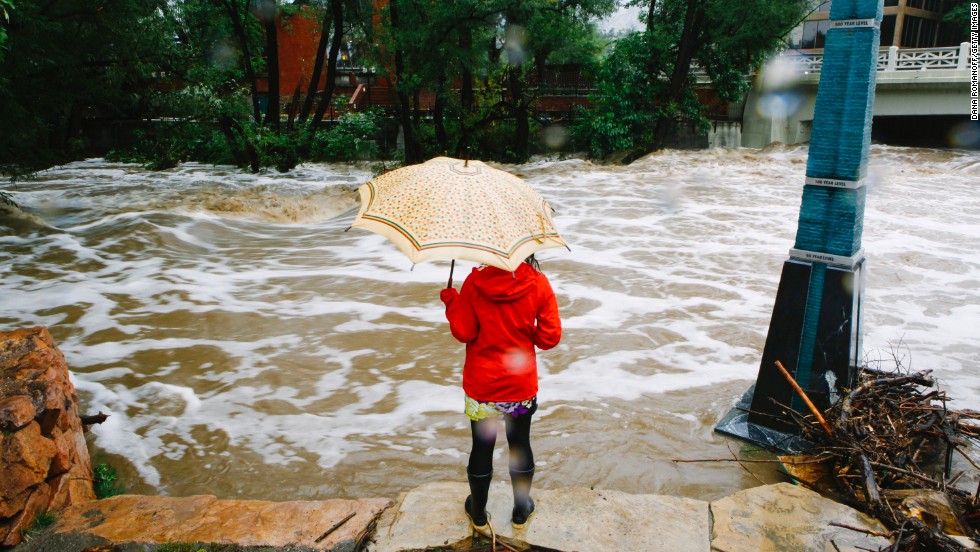 A woman looks at the flooded Boulder Creek on September 12.