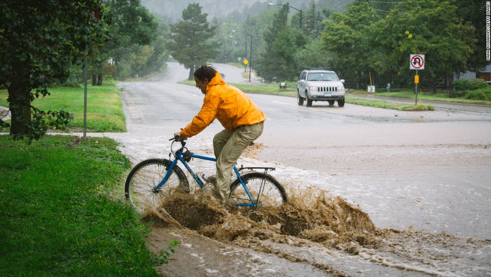 Joey Schusler rides through flooded Canyon Boulevard in Boulder, on September 12.