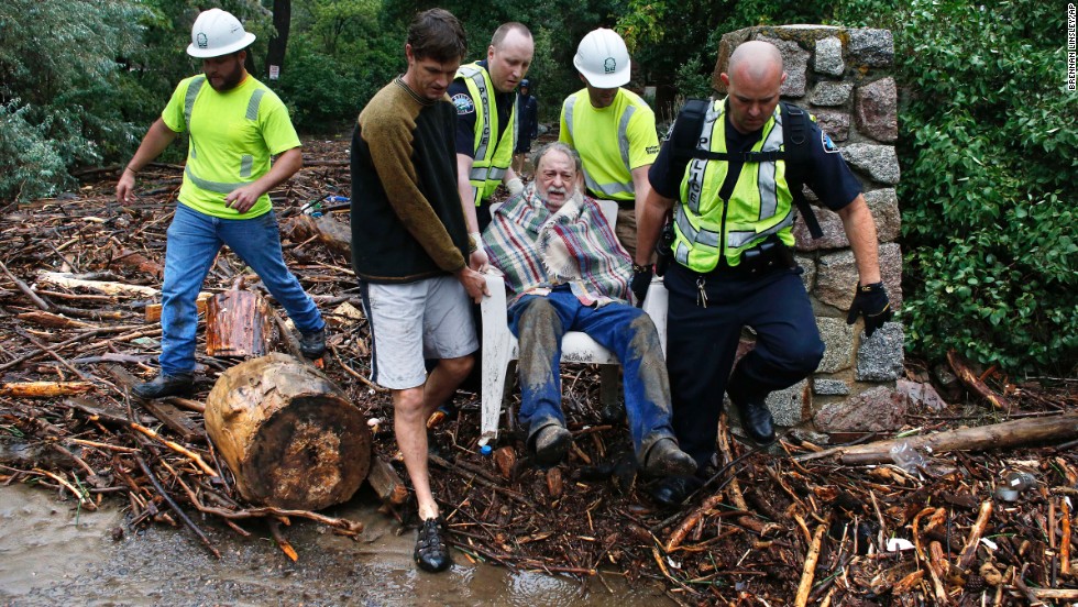 Will Pitner gets rescued by emergency workers and neighbor Jeff Writer on September 13 after he spent a night trapped outside above his home at the base of Boulder Canyon.