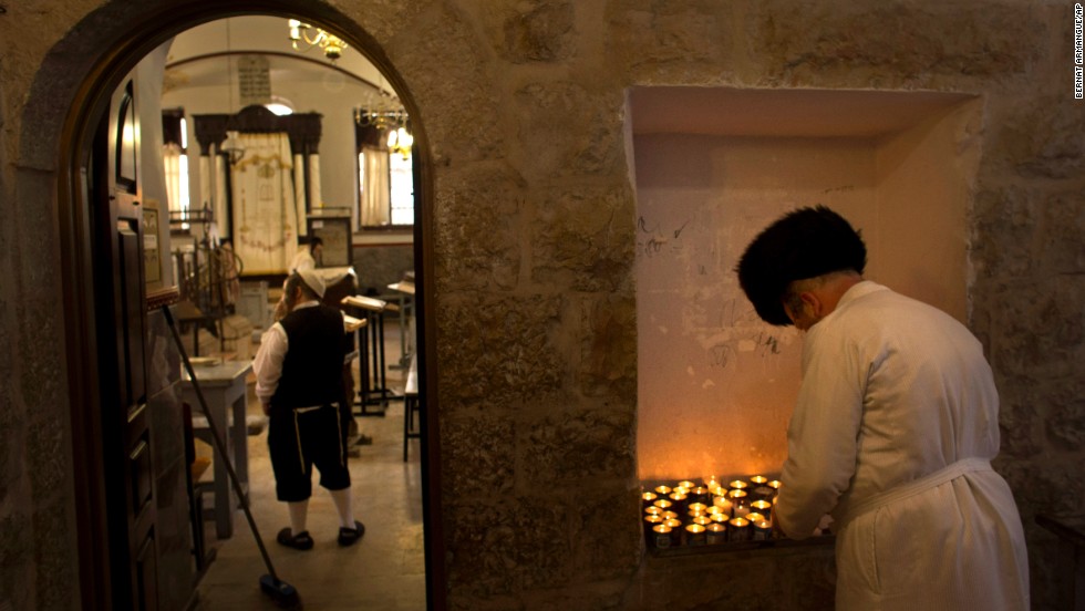 An ultra-Orthodox Jewish man lights a candle ahead of Yom Kippur in Jerusalem.