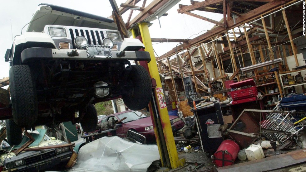Just three weeks after Frances, on September 26, 2004, Hurricane Jeanne&#39;s 60-mile-wide eye crossed the Florida coast near Stuart, at virtually the same place Frances made landfall. Maximum winds were estimated at 120 mph. The storm tore apart this auto shop in Sebastian, Florida. Jeanne was blamed for three deaths in Florida, and one each in Puerto Rico, South Carolina and Virginia.