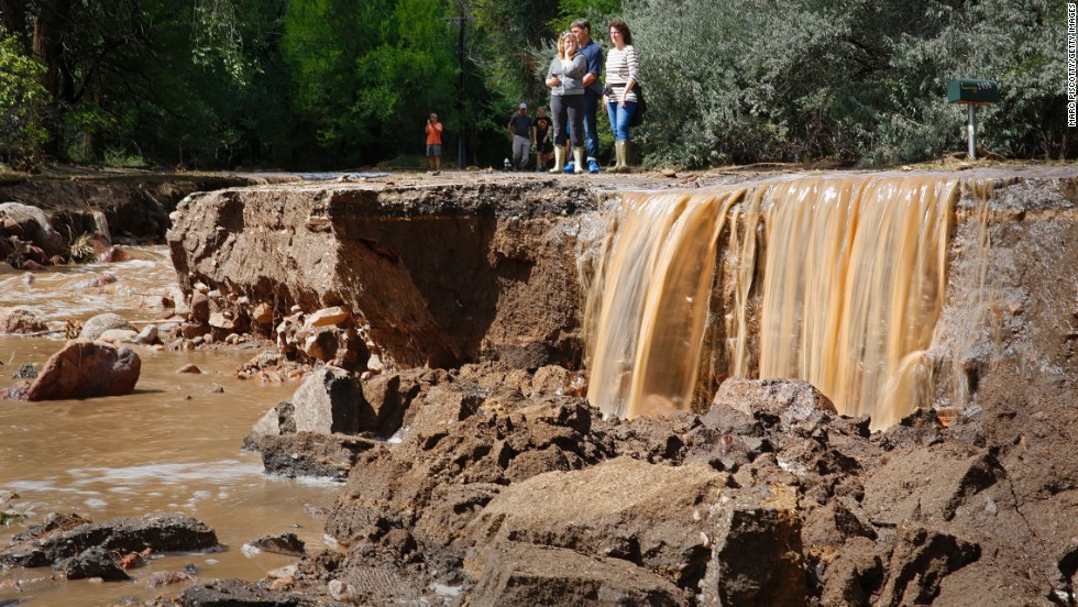 Residents look at the flood damage along Topaz Street in Boulder on September 13.