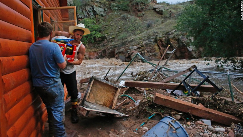 Chris Rodes helps Fred Rob salvage a friend&#39;s belongings after floods left homes and infrastructure in shambles in Lyons, Colorado, on September 13.