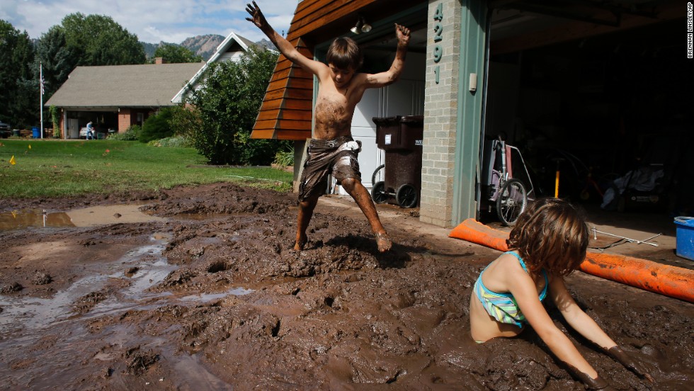 Eli and Noe Sura play in the mud around their Boulder, Colorado, home on September 14. 