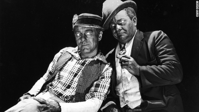 American actors and comedy partners Charles Correll (L) and Freeman Gosden lean against each other in blackface makeup in a 1949 promotional portrait.