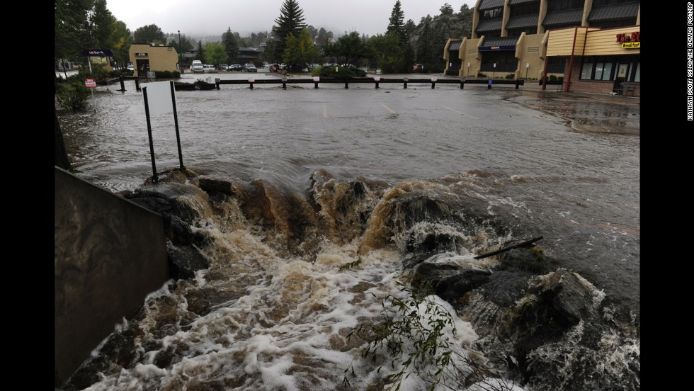 Water pours out of a parking lot, overwhelming a culvert heading under the roadway, in Estes Park, Colorado, on September 15.