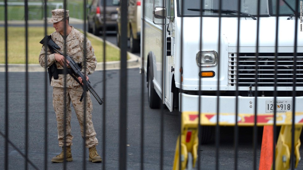 A member of the military stands guard at the scene of the shooting.
