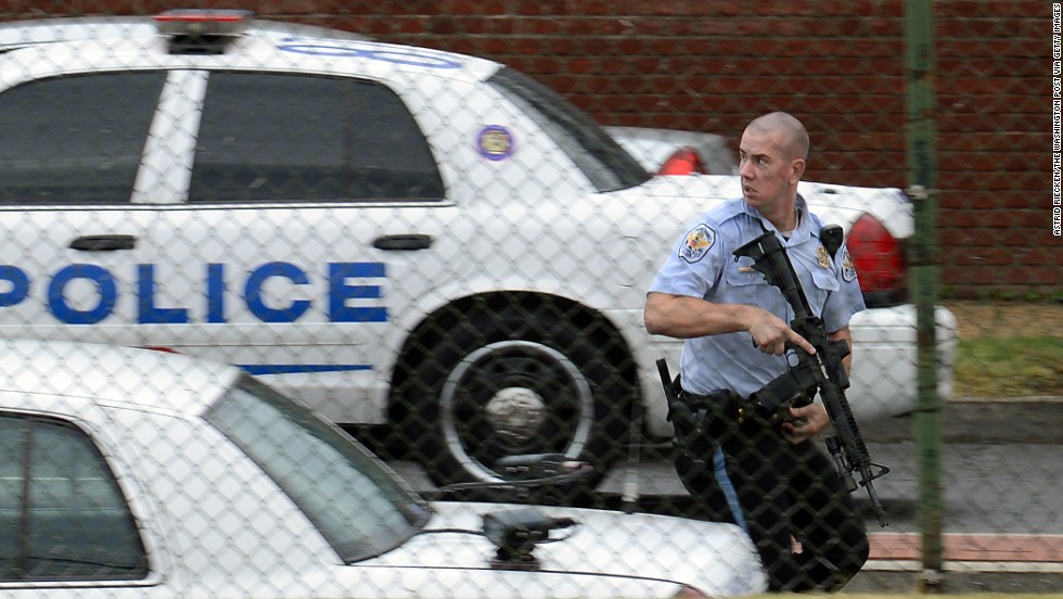 A police officer runs near the scene of the shooting rampage at the Washington Navy Yard on Monday, September 16, 2013. Authorities said at least 12 people -- and the suspect -- were killed in the shooting.