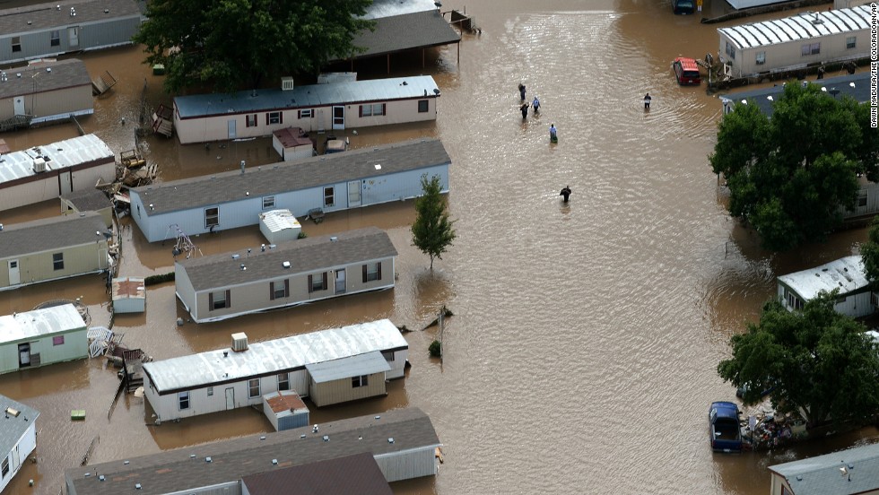 People wade through floodwater in Greeley, Colorado, on September 16.