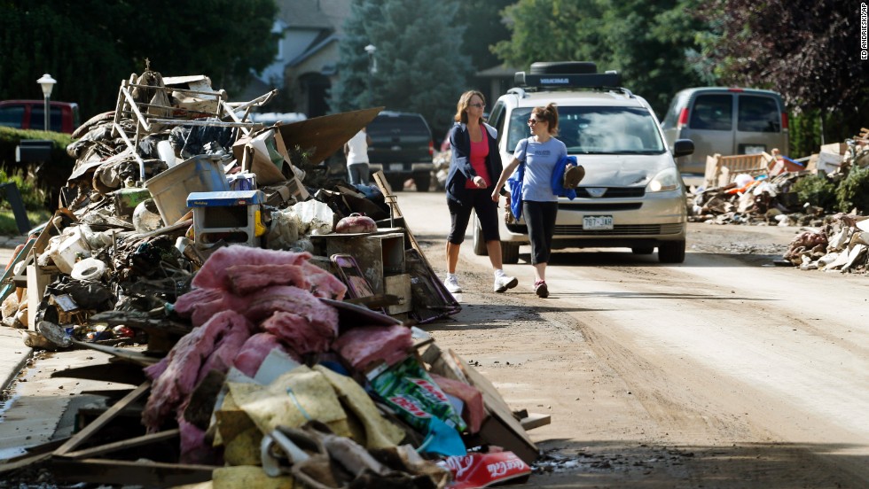 Piles of items destroyed by flooding line both sides of a street in Longmont on September 19. 