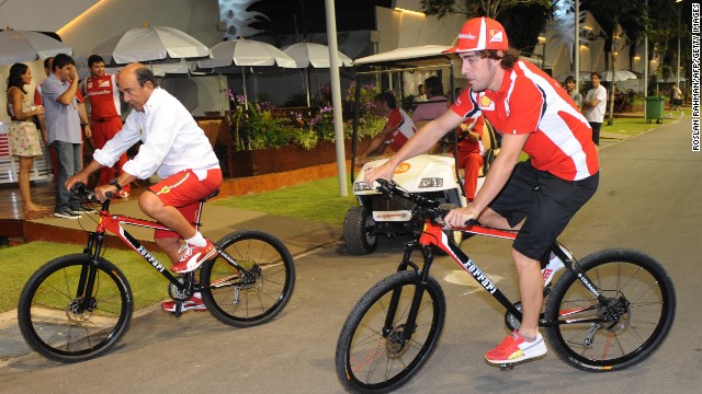 Formula One racer Fernando Alonso, right, hasn&#39;t ruled out starting his own cycling team. 