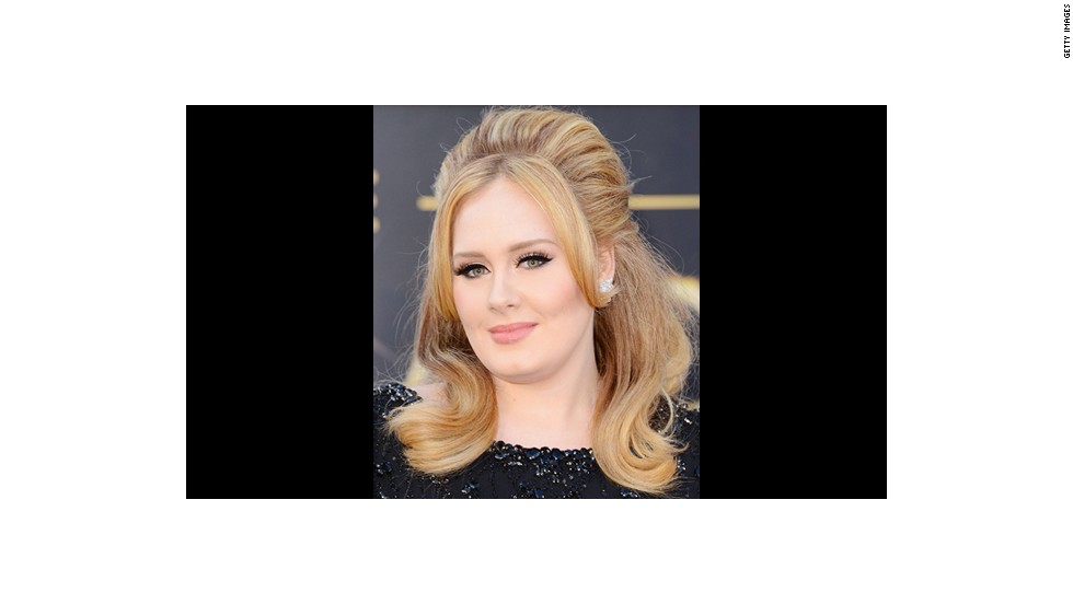 Adele wears jet black winged liner and lush lashes courtesy of makeup artist Michael Ashton.