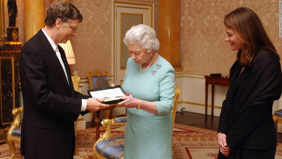 Britain&#39;s Queen Elizabeth II presents Gates with an honorary knighthood, as his wife, Melinda Gates, watches. Despite the 2005 honor, Gates can&#39;t use the title &quot;Sir&quot; because he&#39;s not a British citizen. 