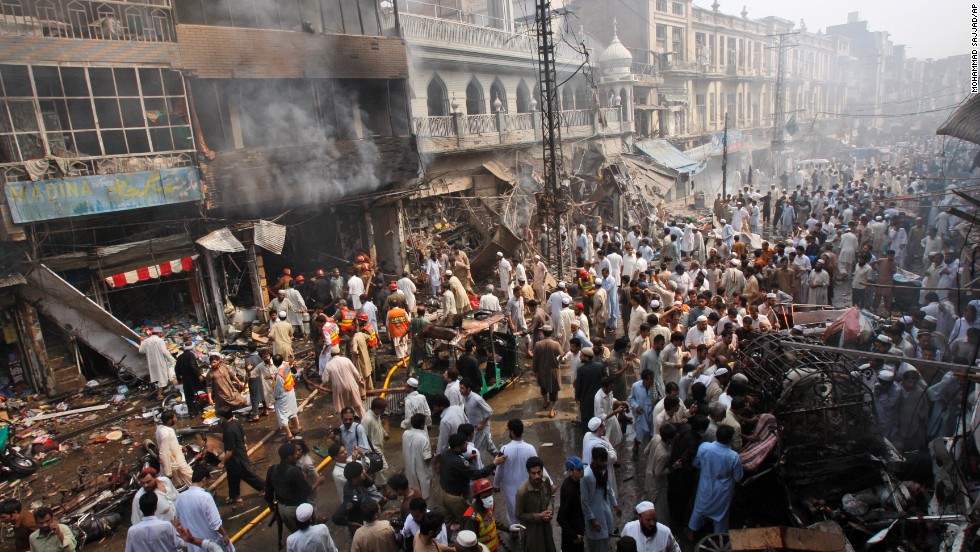 Rescue workers, police officers and civilians gather at the site of a car bomb explosion in Peshawar, Pakistan, on Sunday, September 29. A car loaded with 485 pounds of explosives went off in the city&#39;s historic Qissa Khawani bazaar.