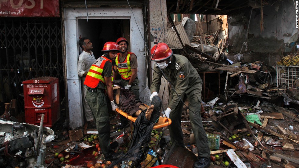 Rescue workers evacuate an injured man from a building at the site of the explosion.
