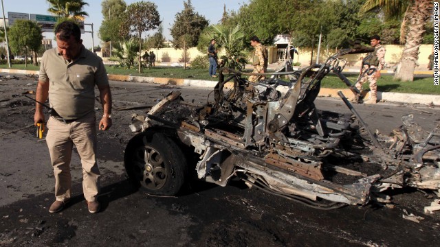 A member of the Iraqi Kurdish security forces inspects the site of a car bomb in Arbil on Sunday.
