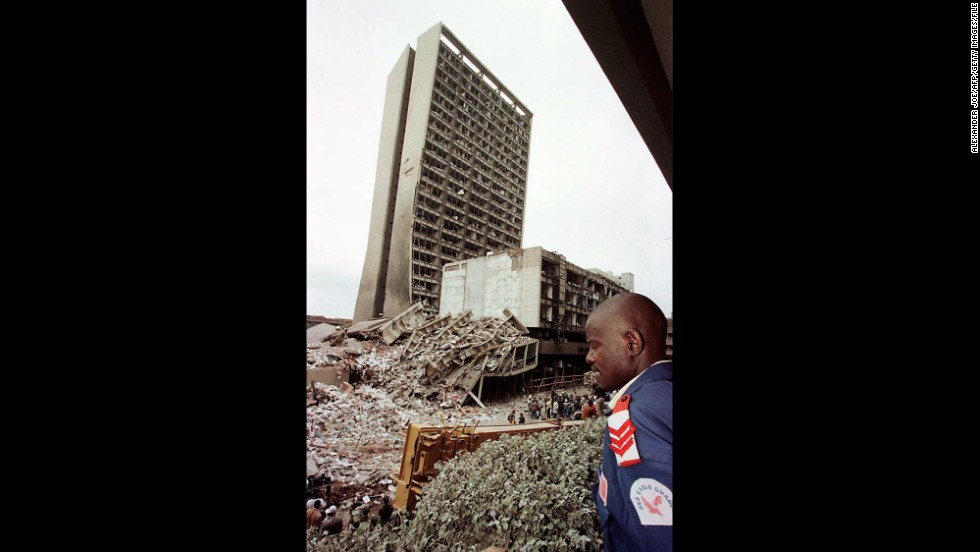 A guard looks over the site of the bomb blast on August 8, 1998, in Nairobi, Kenya.
