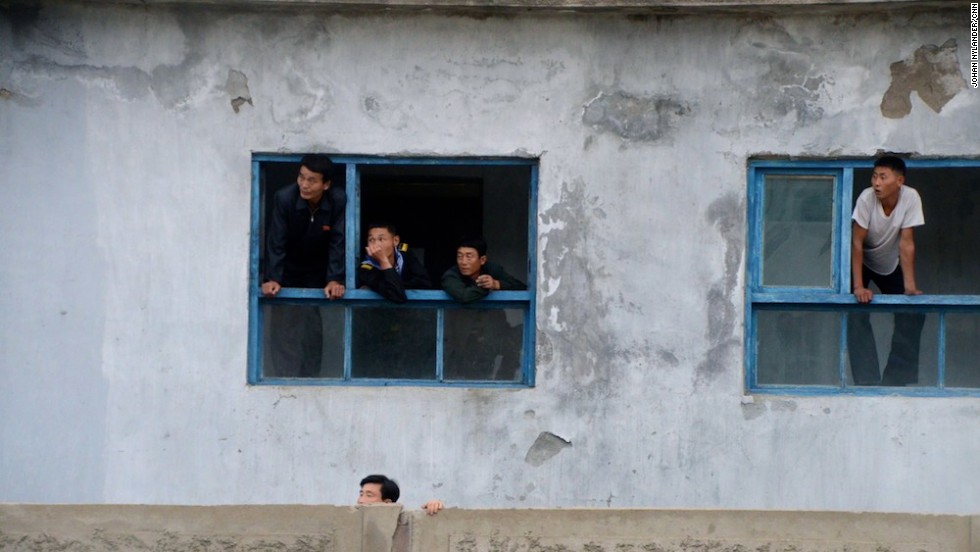 In the city of Rason, people are leaning out of windows to get a glimpse of the Western cyclists. 
