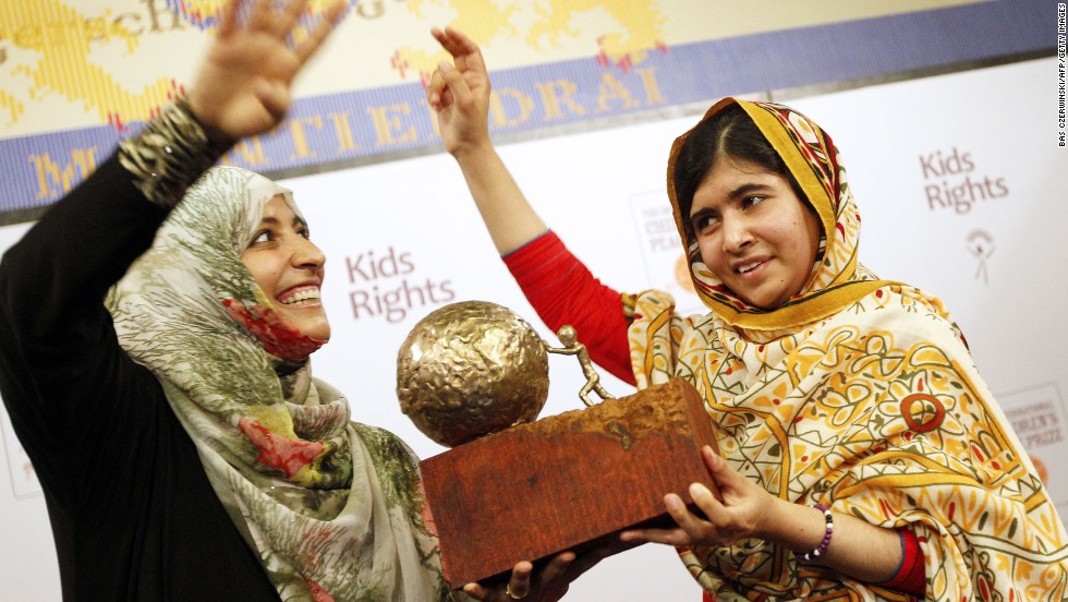 Malala receives a trophy from Yemeni civil rights activist Tawakkol Karman after being honored with the International Children&#39;s Peace Prize in The Hague, Netherlands, in September 2013. Karman was one of the Nobel Peace Prize winners in 2011.