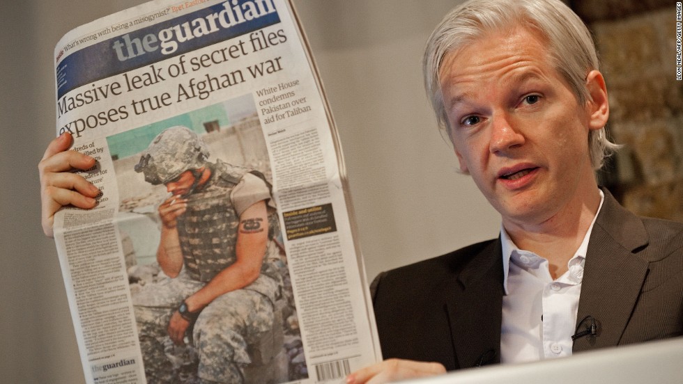 Assange holds a copy of The Guardian newspaper in London on July 26, 2010, a day after WikiLeaks posted more than 90,000 classified documents related to the Afghanistan War.