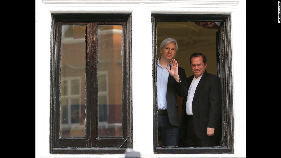 Assange appears with Ecuadorian Foreign Minister Ricardo Patino on the balcony of the embassy in June 2013.