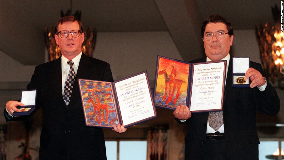 David Trimble, left, and John Hume hold up their diplomas and medals after receiving their Nobel Peace Prize in Oslo, Norway, on December 10, 1998. Trimble and Hume won the Nobel Peace Prize in 1998. 