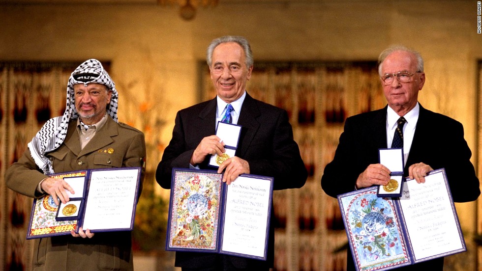 Palestinian leader Yaser Arafat, from left, Israeli Foreign Minister Shimon Peres and Israeli Prime Minister Yitzak Rabin hold up their awards after winning the Nobel Peace Prize in 1994. 
