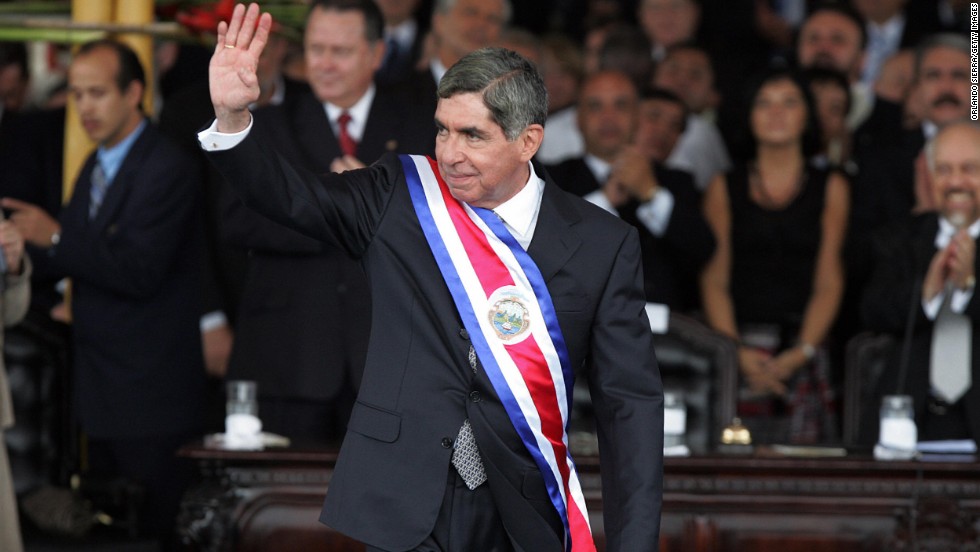 Costa Rican President-elect Oscar Arias waves to supporters after receiving the ceremonial sash at the National Stadium in San Jose on May 8, 2006. Arias won the Nobel Peace Prize in 1987. 