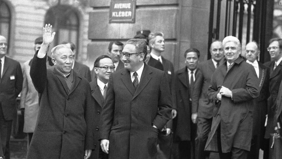 Hanoi&#39;s delegate Le Duc Tho cheers to the crowd while leaving the International Conference Center in Paris on January 23, 1973, after meeting with presidential adviser Henry Kissinger, center. Le Duc Tho and Kissinger won the Nobel Peace Prize in 1973. 