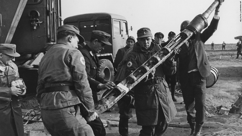 A group of Red Cross rescue workers hold a capsule used to supply food and beverages to three trapped miners at an iron ore mine near Lengede, Germany, on October 28, 1963. The League of Red Cross Societies won the Nobel Peace Prize in 1963. 