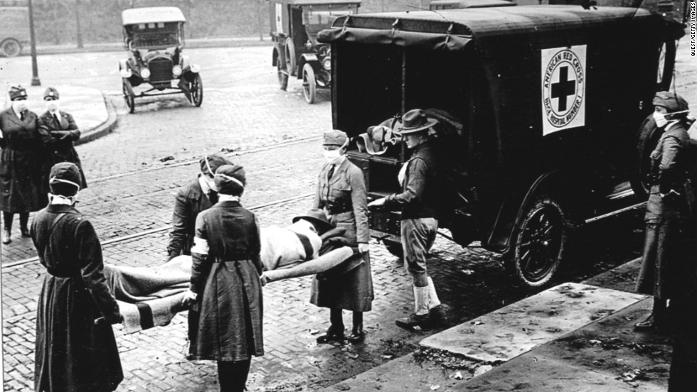 Members of the Red Cross Motor Corps, all wearing masks to protect against the further spread of the influenza epidemic, carry a patient on a stretcher into an ambulance in St. Louis in October 1918. The International Committee of the Red Cross won the Nobel Peace Prize in 1917. 