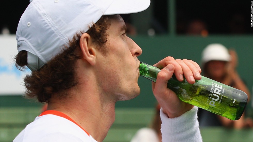 2013 Wimbledon champion Andy Murray jokingly drinks a bottle of beer given to him by at an exhibition in Australia, but like other star players he has cut out alcohol altogether.
