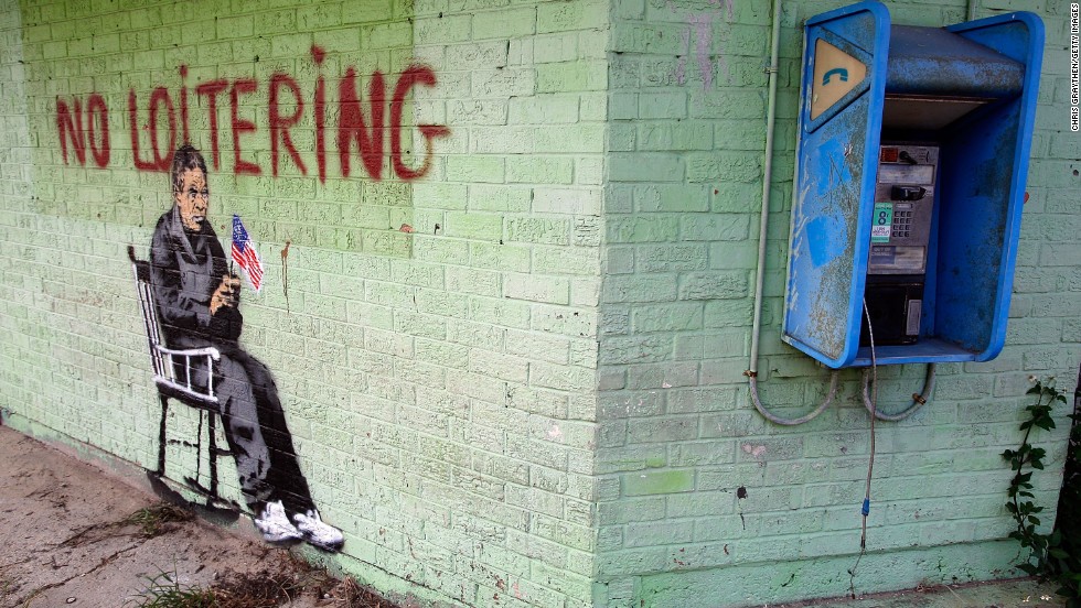Graffiti on the side of a building in New Orleans shows an elderly person in a rocking chair under the banner, &quot;No Loitering,&quot; in 2008.