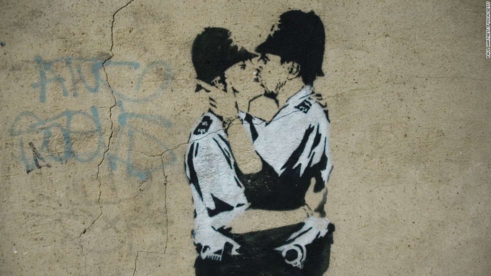 A stenciled image of two policemen kissing is seen in London in 2005.