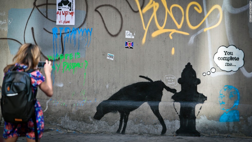 A Banksy mural of a dog urinating on a fire hydrant draws attention