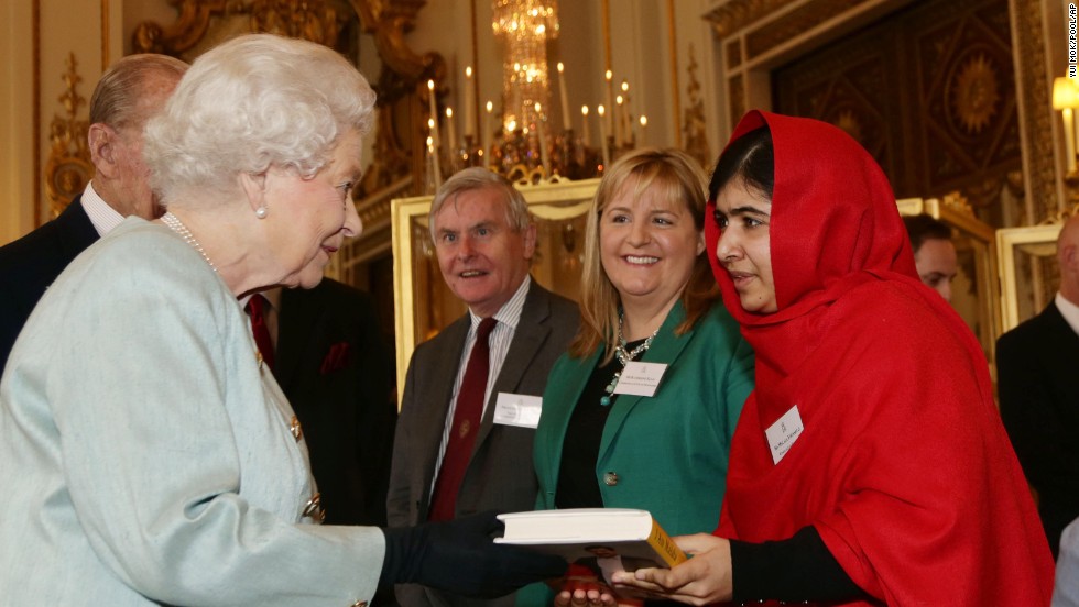 Malala gives a copy of her book to Britain&#39;s Queen Elizabeth II during a reception at Buckingham Palace in October 2013.