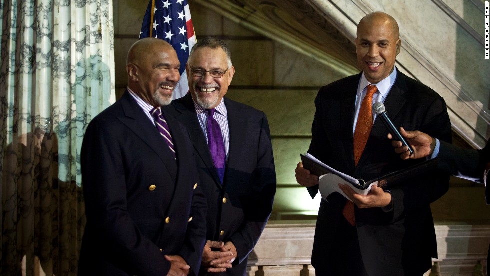On October 21, 2013, Cory Booker, right, officiates a wedding ceremony for Joseph Panessidi, center, and Orville Bell at the Newark, New Jersey, City Hall. The New Jersey Supreme Court denied the state&#39;s request to prevent same-sex marriages temporarily, clearing the way for same-sex couples to marry.