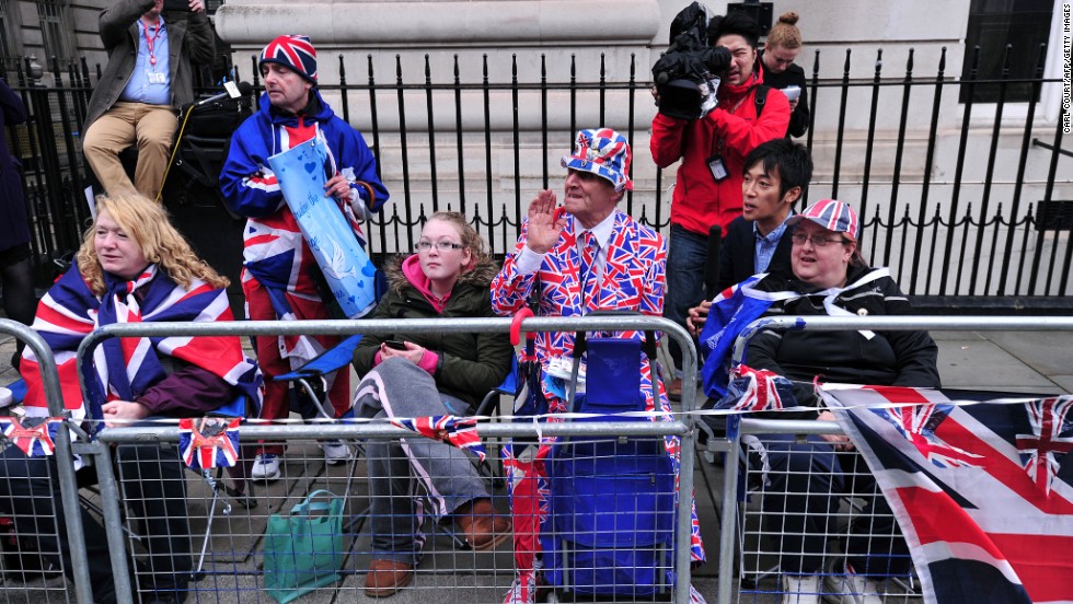 Spectators sport the colors as they wait for the royal family to arrive. 
