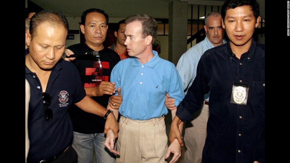 Thai police officials escort U.S. teacher John Mark Karr at the Thai Immigration Department in Bangkok on August 17, 2006. Officials announced Karr as a suspect in the case. Karr said he was present when JonBenet died, and that he loved her and her death was an accident. On August 26, 2006, the Boulder County District Attorney decided not to charge Karr in connection with the murder after DNA tests confirmed that he wasn&#39;t a match to the evidence found at the crime scene.