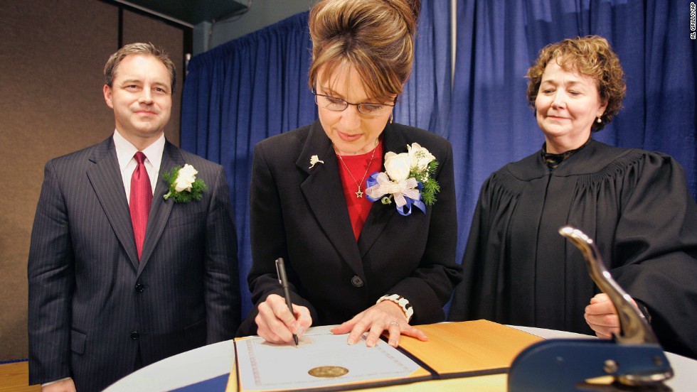 Palin signs her oath of office document as Lt. Gov. Sean Parnell, left, and Superior Court Judge Niesje Steinkruger look on after her swearing-in ceremony in Fairbanks, Alaska, in December 2006.