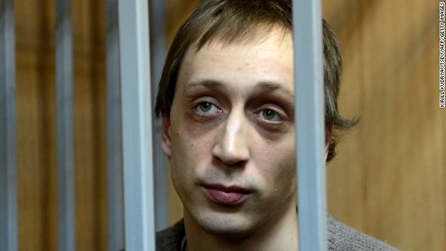 Pavel Dmitrichenko, a leading dancer at Russias Bolshoi Theatre, looks on as he stands inside the defendant&#39;s cage during a court hearing in Moscow, on October 22, 2013. 