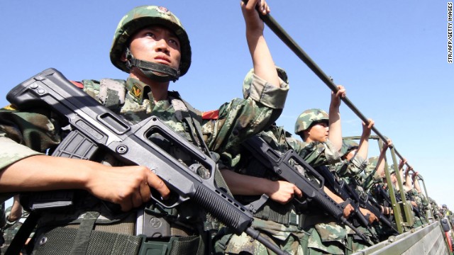 An anti-terrorism force holds exercises in Hami, in northwest China&#39;s Xinjiang region in July. 