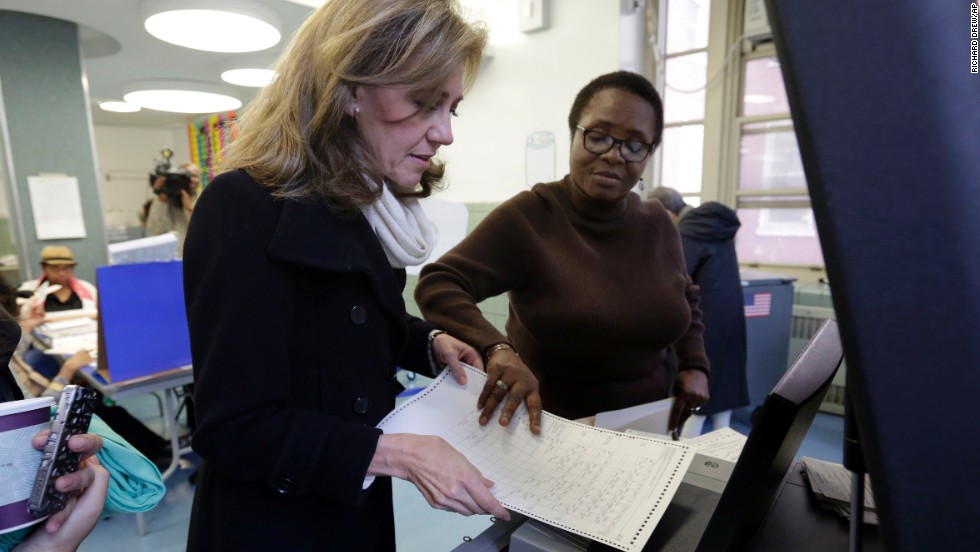 Silda Wall Spitzer, wife of former New York Gov. Eliot Spitzer, has her ballot scanned by Edith Maduakolam at Public School 6. 