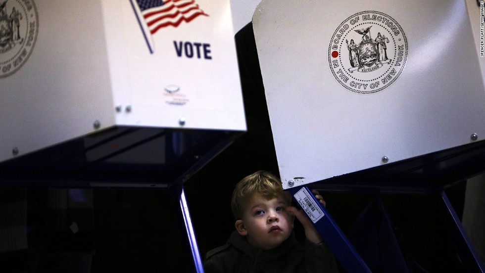 Tobias Nichols, 2, waits for his father, Dan Nichols, to vote in Brooklyn.