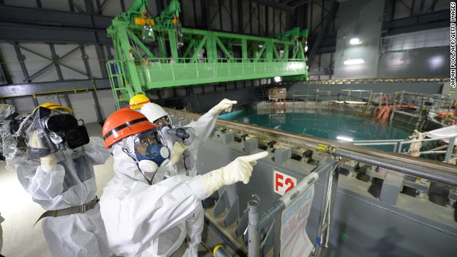 Fukushima Governor Yuhei sato (orange helmet) inspects the spent fuel pool in the unit 4 reactor building of Tokyo Electric Power Co (TEPCO) Fukushima Dai-ichi nuclear power plant at Okuma town in Fukushima prefecture on October 15, 2013. Sato also inspected contamination water tanks as radioactive water leaked early this month. AFP PHOTO / JAPAN POOL via JIJI PRESS JAPAN OUT (Photo credit should read JAPAN POOL/AFP/Getty Images)