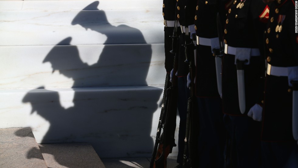 Members of the military stand at attention before Monday&#39;s ceremony at the Tomb of the Unknowns.