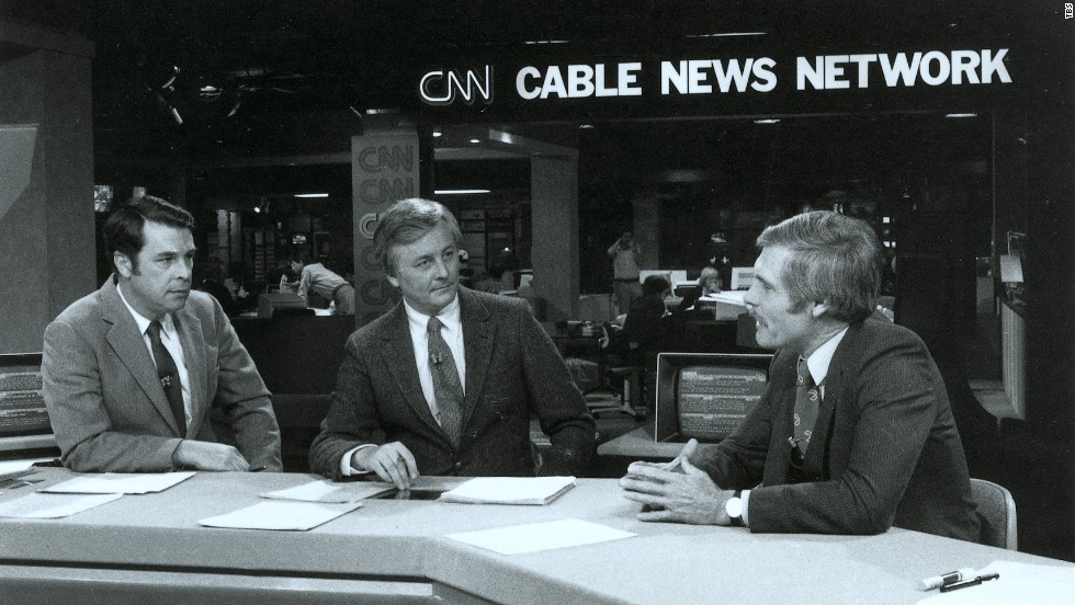 Turner, right, talks on the set of an early CNN broadcast.