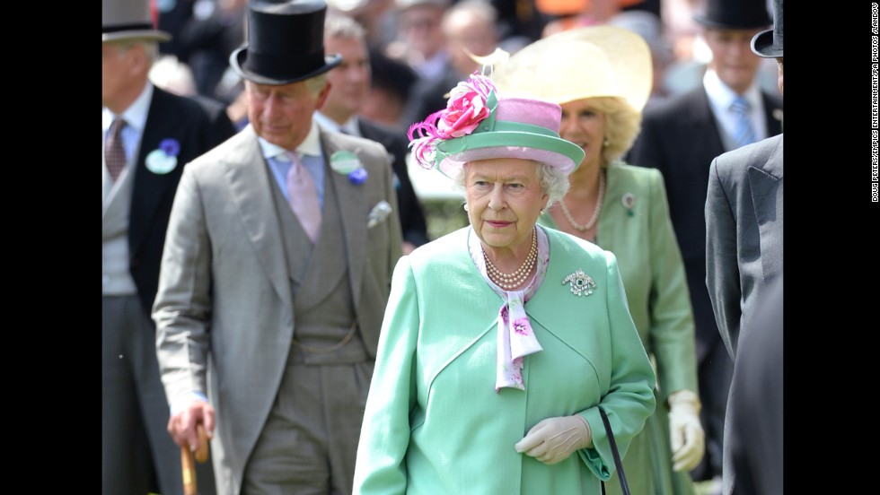 Charles strolls behind his mother in a top hat and umbrella on day two of the Royal Ascot Meeting 2013 horse race in Berkshire.