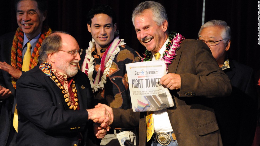 On November 13, 2013, Hawaii Gov. Neil Abercrombie, left, and former state Sen. Avery Chumbley celebrate with a copy of the Honolulu Star-Advertiser after Abercrombie signed a bill legalizing same-sex marriage in the state.